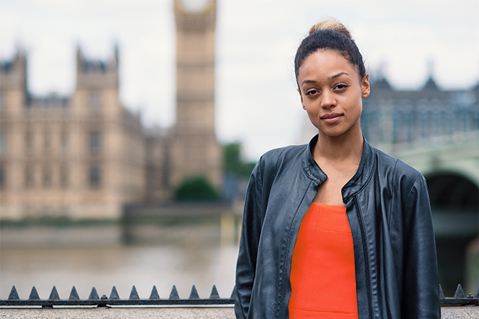 Young businesswoman close up portrait outdoors in London with Big Ben as background.