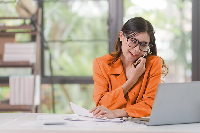 Young Asian woman speaking on phone