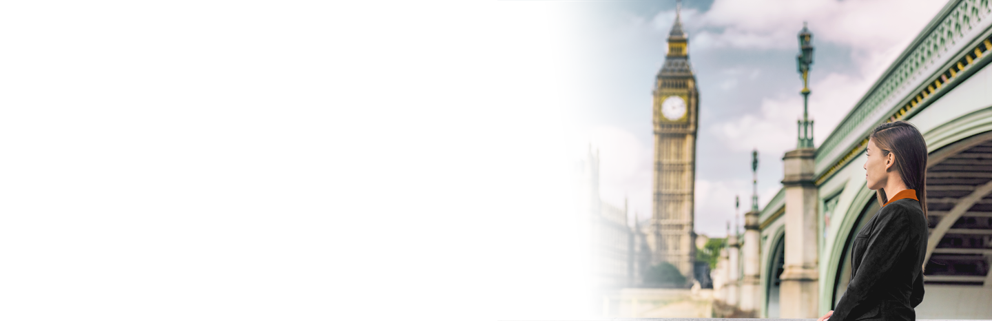 Young woman looking out over London bridge and big ben clock tower